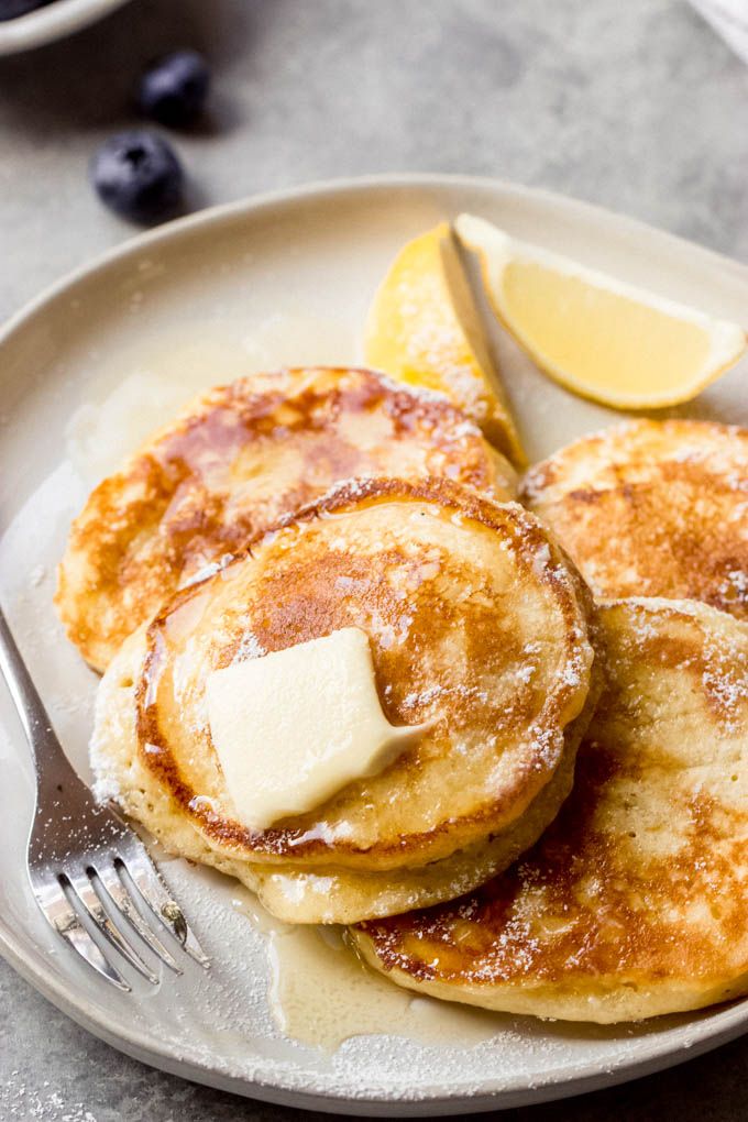 pancakes with butter and blueberries on a plate