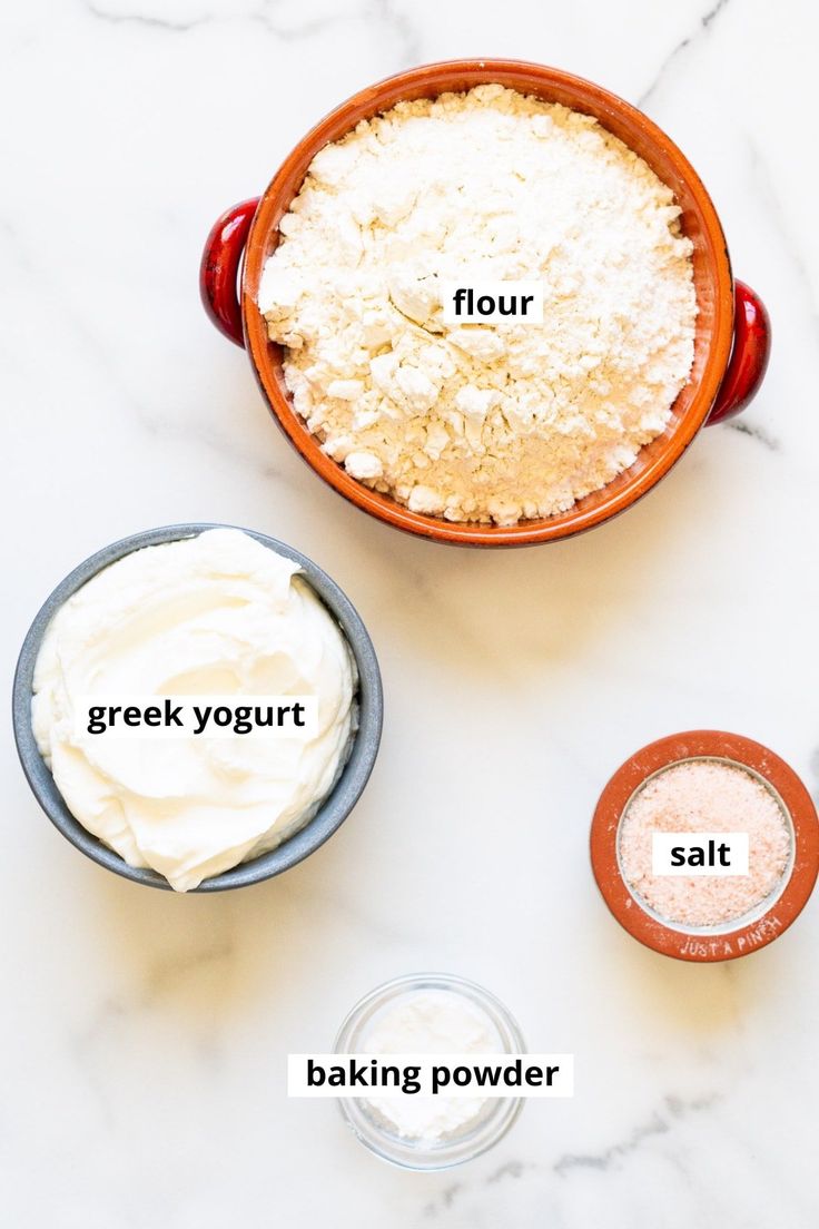 ingredients for greek yogurt in bowls on a marble counter top with the words, flour, salt, and baking powder