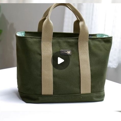 a green tote bag sitting on top of a table