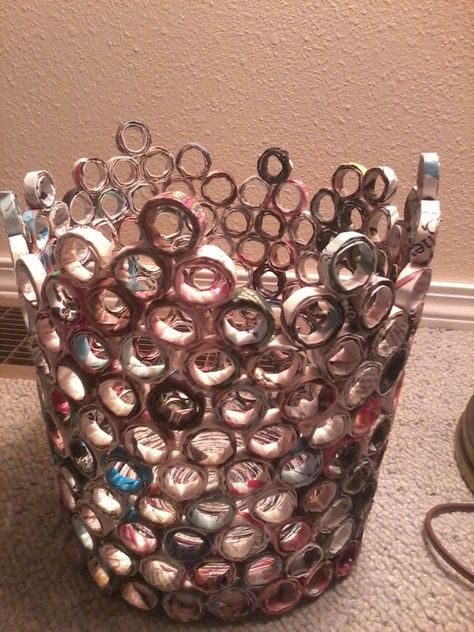 a silver vase sitting on top of a carpeted floor