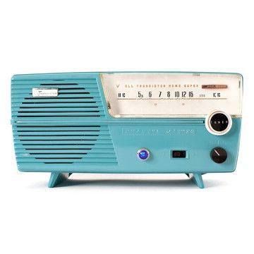 an old fashioned radio sitting on top of a blue stand with the time at 11 00 pm