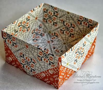 an orange and white paper box sitting on top of a table