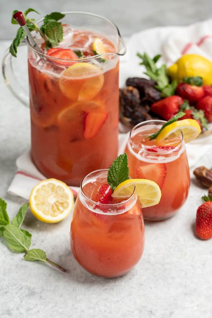 two glasses filled with strawberry lemonade and garnish