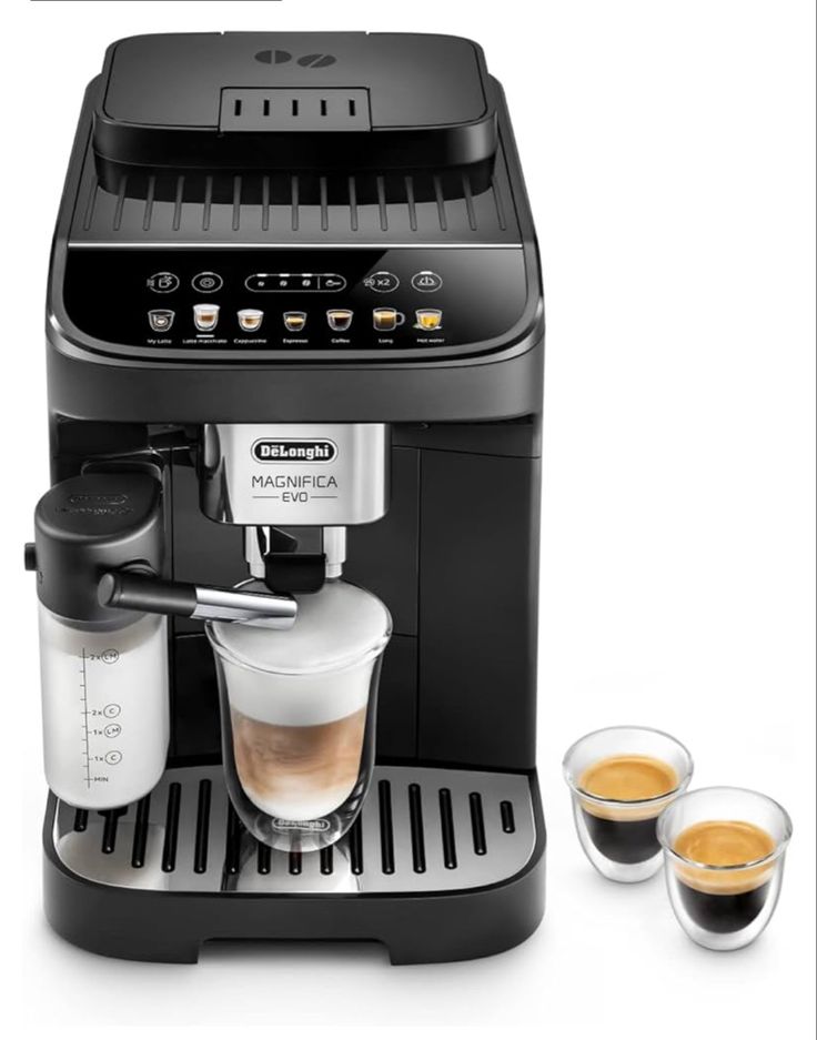 an espresso machine with two cups of coffee next to it on a white background