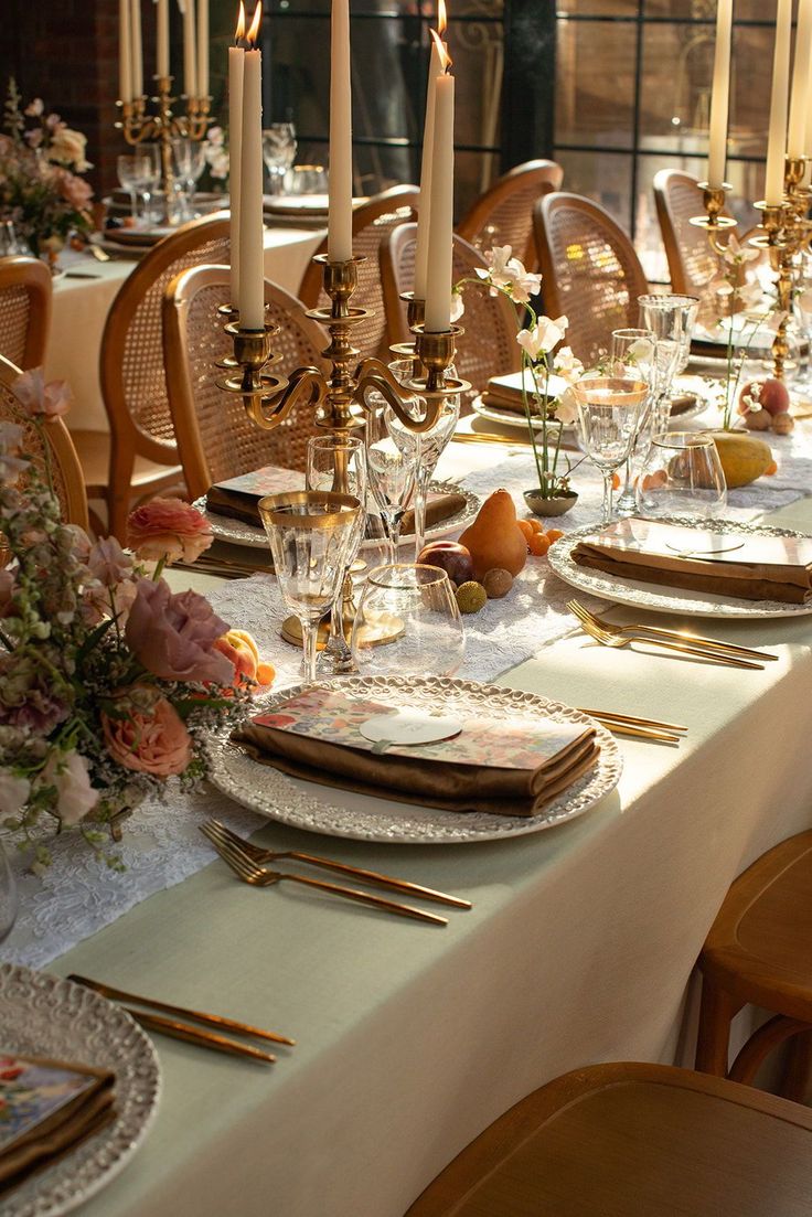 a table set with place settings and candles