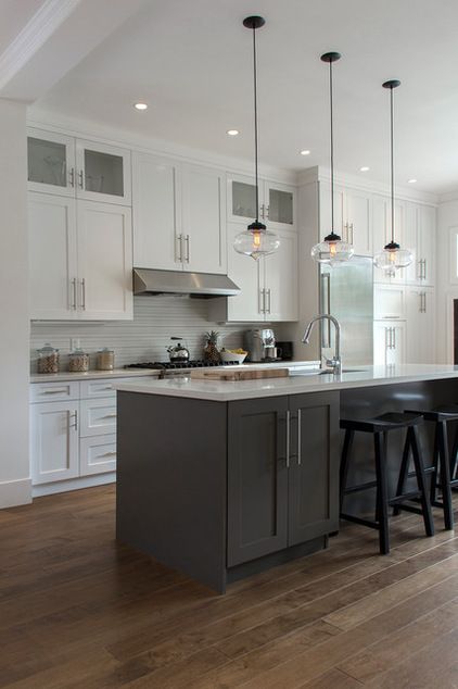 a large kitchen with white cabinets and black bar stools in front of an island