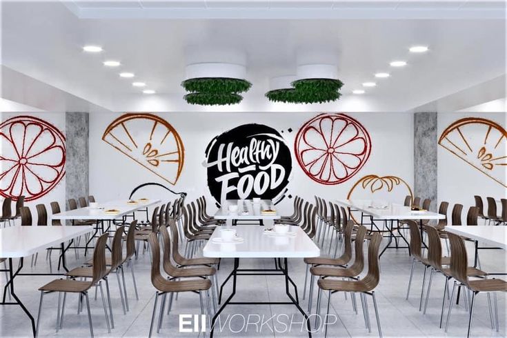 an empty restaurant with tables and chairs in front of the wall that says healthy food