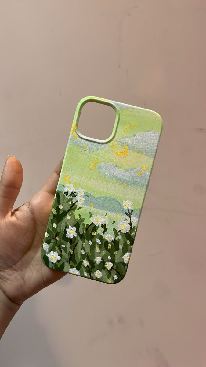 a hand holding up a cell phone case with flowers on the front and bottom cover