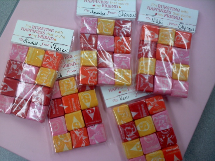 several pieces of candy sitting on top of a pink table