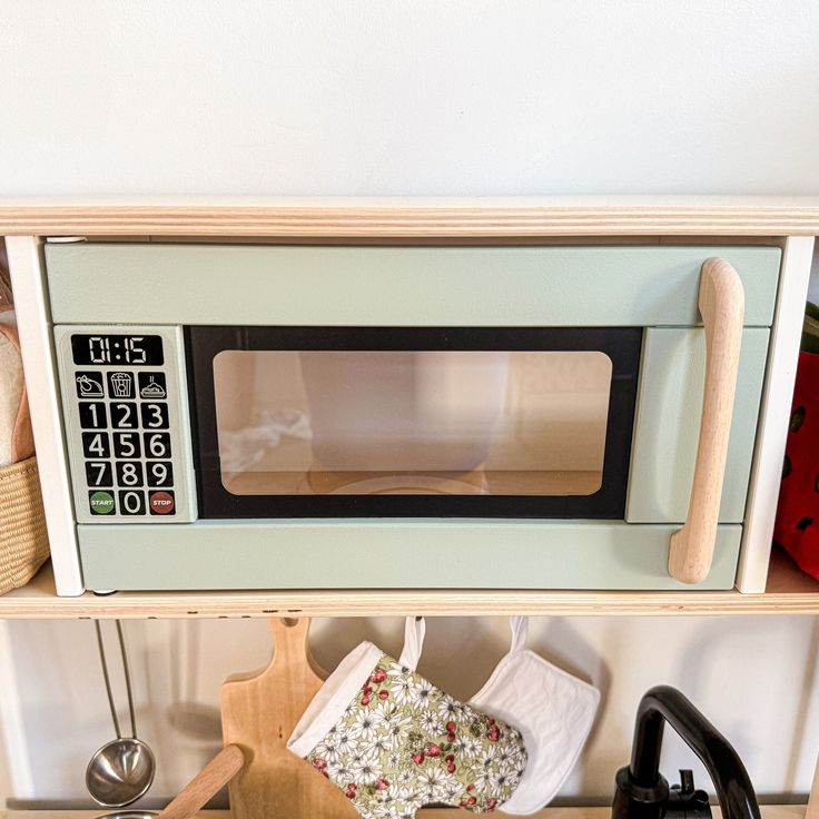 a microwave oven sitting on top of a wooden shelf