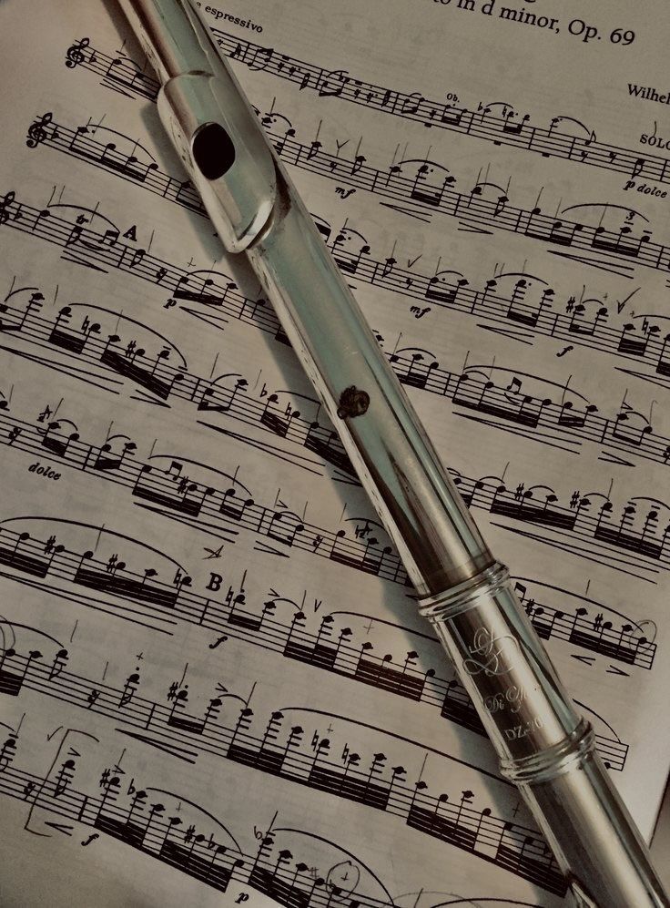 a fountain pen sitting on top of sheet music