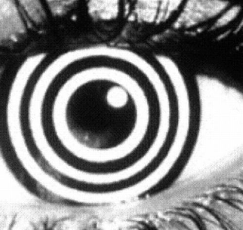 an eye with black and white circles in the iris, as if it were looking at something