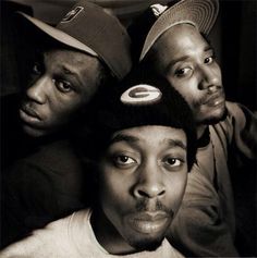 three men are posing for the camera with one man's hat on his head