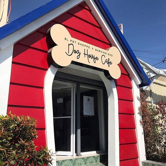 a red and white building with a sign that says dog house cafe