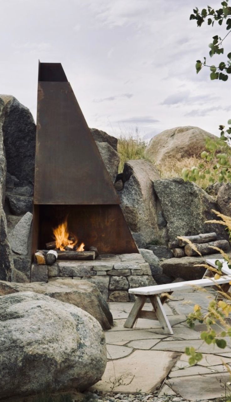 a fire pit in the middle of some rocks