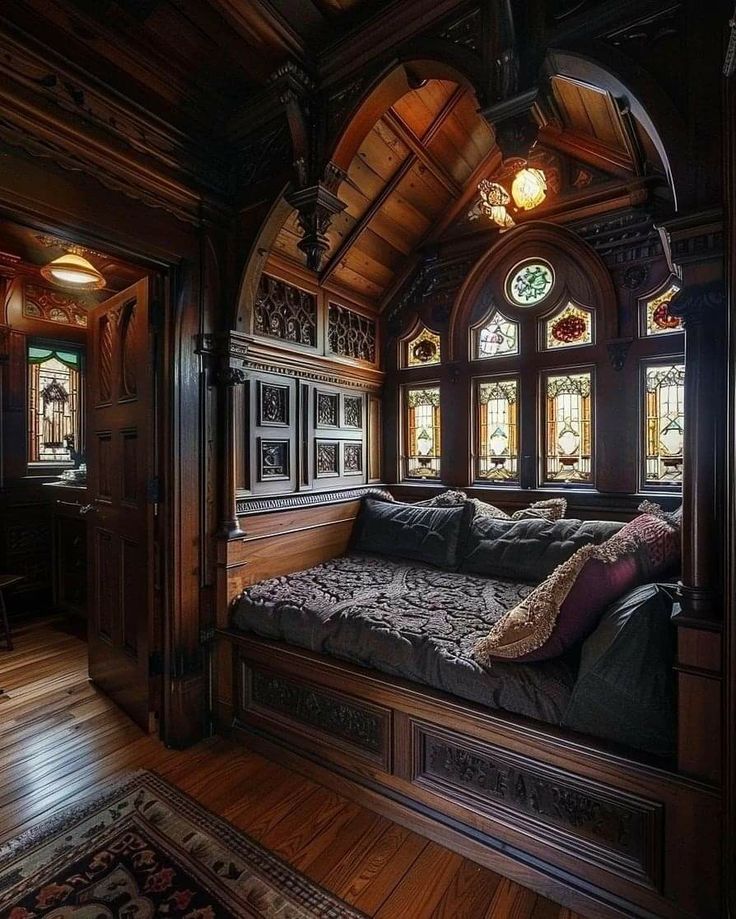 a large bed sitting in the middle of a room next to a wooden floor and windows