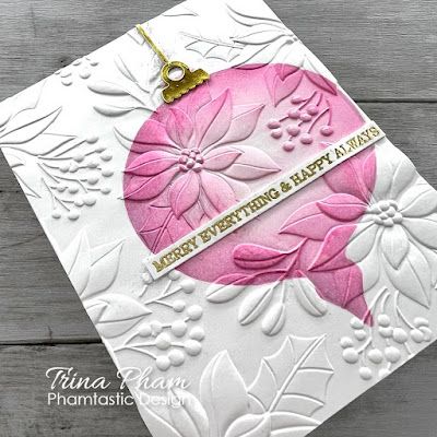 a white card with pink flowers on it and a gold key hanging from the front