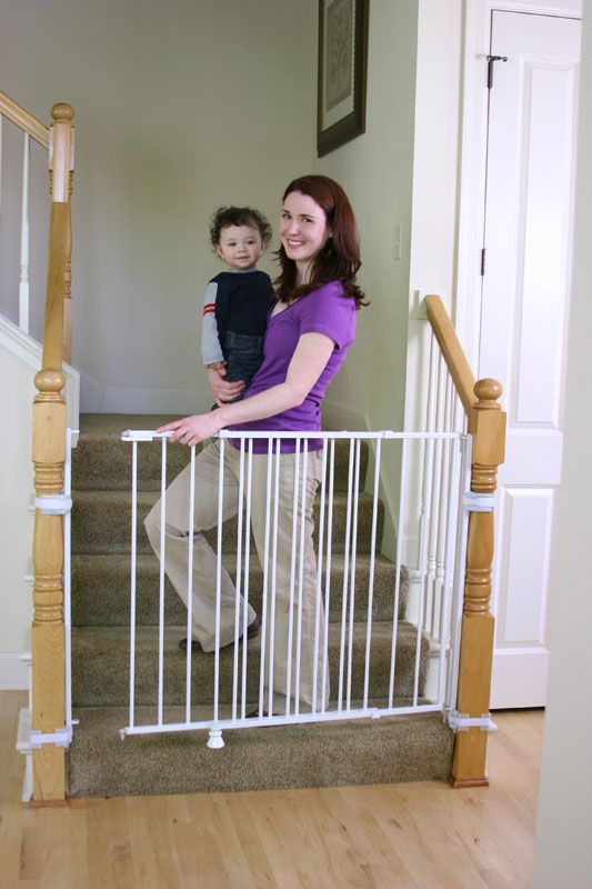 a woman and child standing at the bottom of stairs