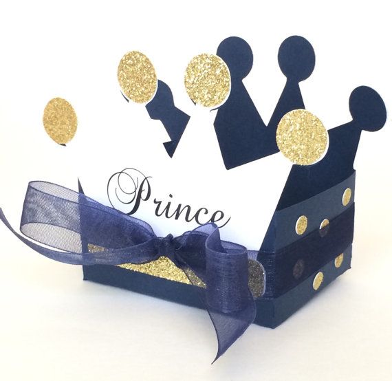 a paper crown with gold glitters on it and the word prince written in black