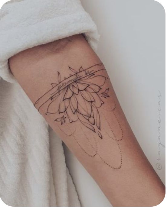 a woman's arm with a tattoo on it and a flower in the middle