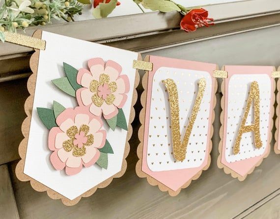 a banner with flowers and letters hanging from the side of a fireplace mantel that says va