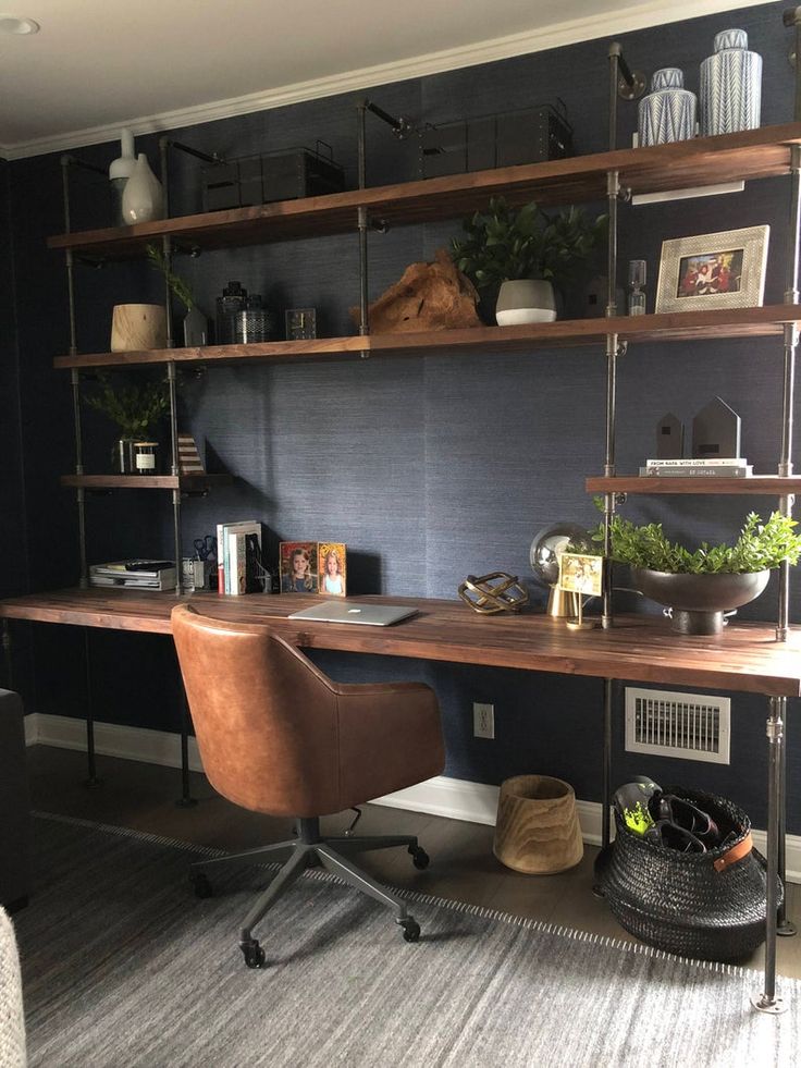 a home office with shelving and shelves on the wall