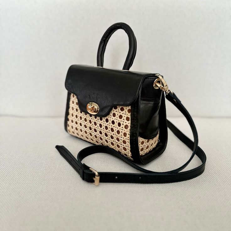 Our Mini Rattan Purse packs a punch when it comes to summertime style. It’s small enough to take anywhere, but the unique shape and contrasting textures make it the ultimate finishing touch. This bag is poised to be your newest wardrobe staple and, with a detachable crossbody strap, how you wear it is up to you. Detachable crossbody strap Crafted with rattan and leather Height: 6" (9" with strap), Width: 8", Depth: 4" Summer Handheld Satchel With Leather Handles, Black Straw Bag With Detachable Strap For Vacation, Chic Leather Rectangular Straw Bag, Everyday Summer Box Bag With Top Carry Handle, Handheld Satchel For Summer, Leather Shoulder Bag With Top Carry Handle For Summer, Chic Natural Box Bag For Summer, Chic Handheld Satchel In Natural Color, Chic Handheld Straw Bag With Detachable Strap