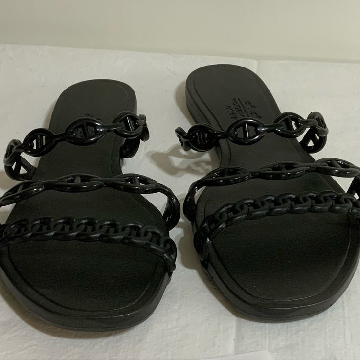 Size 40 But Fits Like Size 8. Like New, Never Worn Black Slip-on Synthetic Jelly Sandals, Black Synthetic Slip-on Jelly Sandals, Black Flat Jelly Sandals For Party, Black Open Toe Jelly Sandals, Chic Black Jelly Sandals With Round Toe, Black Jelly Sandals For Beach, Black Flat Heel Jelly Sandals For Beach, Black Flat Jelly Sandals For Beach, Trendy Black Jelly Sandals With Flat Heel