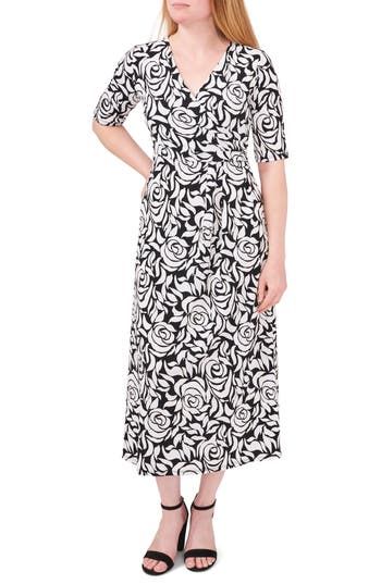 A bold floral print blooms on a stretchy midi dress fashioned with a flattering surplice neck and elbow-length sleeves for a versatile addition to your closet. 48" length Surplice V-neck Elbow-length sleeves 96% polyester, 4% spandex Machine wash, tumble dry Made in the USA Floral Print Midi Dress With Surplice Neckline For Evening, White Floral Print Midi Dress With 3/4 Sleeves, White Midi Dress With Floral Print And 3/4 Sleeves, Fitted Floral Print Maxi Dress With 3/4 Sleeves, Chic Midi Dress With Floral Print And 3/4 Sleeves, Elegant Floral Print 3/4 Length Dress, Fitted Floral Print Maxi Dress With Half Sleeves, Black Midi Dress With Floral Print And 3/4 Sleeve, Chic Half Sleeve Midi Dress With Floral Print