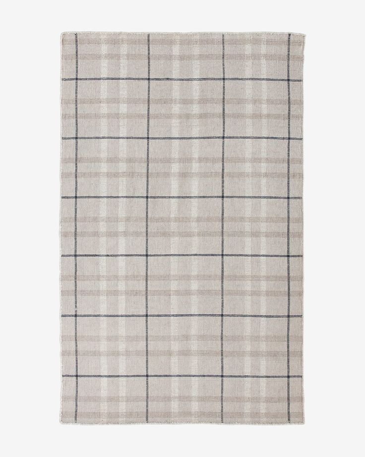 a beige and black plaid rug on a white background