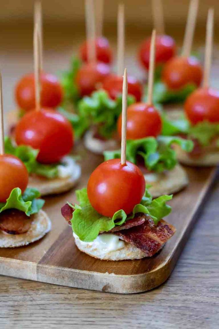 mini sandwiches with bacon, lettuce and tomato on them are ready to be eaten