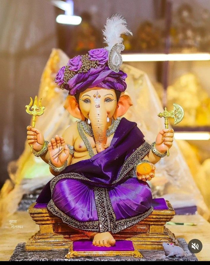 an elephant statue sitting on top of a wooden table