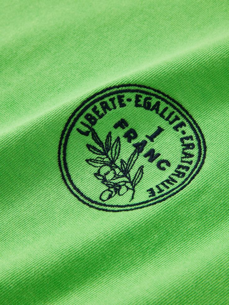 Details: Youthful and vibrant green tinted tee with a touch of nature.Fitted short fitEmbroidered design on the chestIt is cool and suitable for spring and summer wear. Materials & Care: Cotton: 63.3%; Polyester: 20.6%; Lycra: 16.1% Hand wash | Dry clean Do not bleach Size & Fit: Model is 5'7", Bust 32, Waist 24, Hips 35, wearing a size S Item #: LN1TE22 Casual Green Tops With Embroidered Logo, Spring Green Tops With Embroidered Logo, Green Spring Tops With Embroidered Logo, Spring Green Top With Embroidered Logo, Green Spring Top With Embroidered Logo, Green Cotton Tops With Embroidered Logo, Green Cotton Top With Embroidered Logo, Spring Green T-shirt With Embroidered Graphics, Casual Green T-shirt With Embroidered Logo