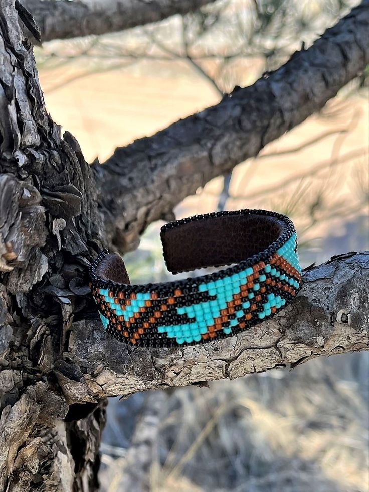 a bracelet that is sitting on a tree branch