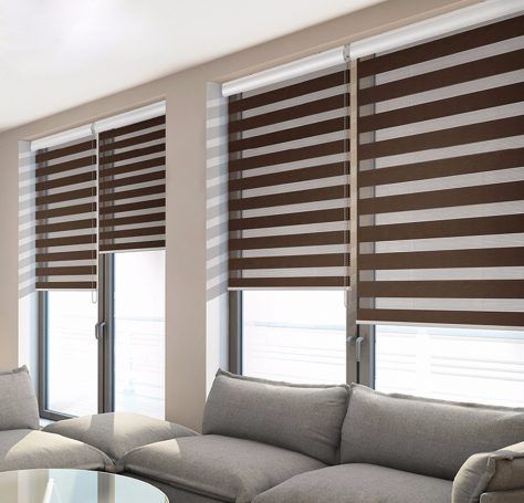 a living room with two couches and windows covered in blind shades on the walls