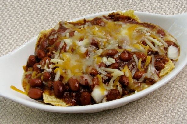 a white bowl filled with beans and cheese