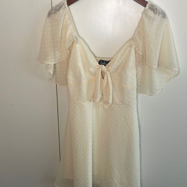 Moving Sale- Make An Offer Stunning Cream/Ivory Mini Dress With Flowy Sleeves And Tie Front Bust So Flattering And Cute Size Medium Brand New With Tags Cream Mini Dress With Flowy Fit, Elegant Cream Mini Dress For Daytime, Cream Bohemian Flowy Mini Dress, Vintage Flowy V-neck Mini Dress, Flowy Cream Bohemian Mini Dress, Cream V-neck Dresses For Daytime, Cream Flowy V-neck Mini Dress, White Denim Dress, Lace Ruffle Dress