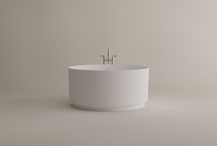 a white bath tub sitting next to a faucet on top of a wall