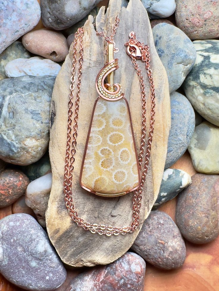 Indonesian agatized coral with copper and gold wire wrap Comes with 20" sterling silver plated chain shown in photos.  Pendant measures 2-7/16" x  1" Hand Wrapped Gold Agate Necklaces, Hand Wrapped Gold Agate Necklace, Wire Wrapped Ocean Jasper Pendant Necklaces, Ocean Jasper Wire Wrapped Pendant Necklaces, Wire Wrapped Ocean Jasper Pendant Necklace, Hand Wrapped Carnelian Pendant Jewelry, Gold Agate Wire Wrapped Necklace, Hand-wrapped Jasper Pendant Necklace, Gold Agate Wire Wrapped Jewelry