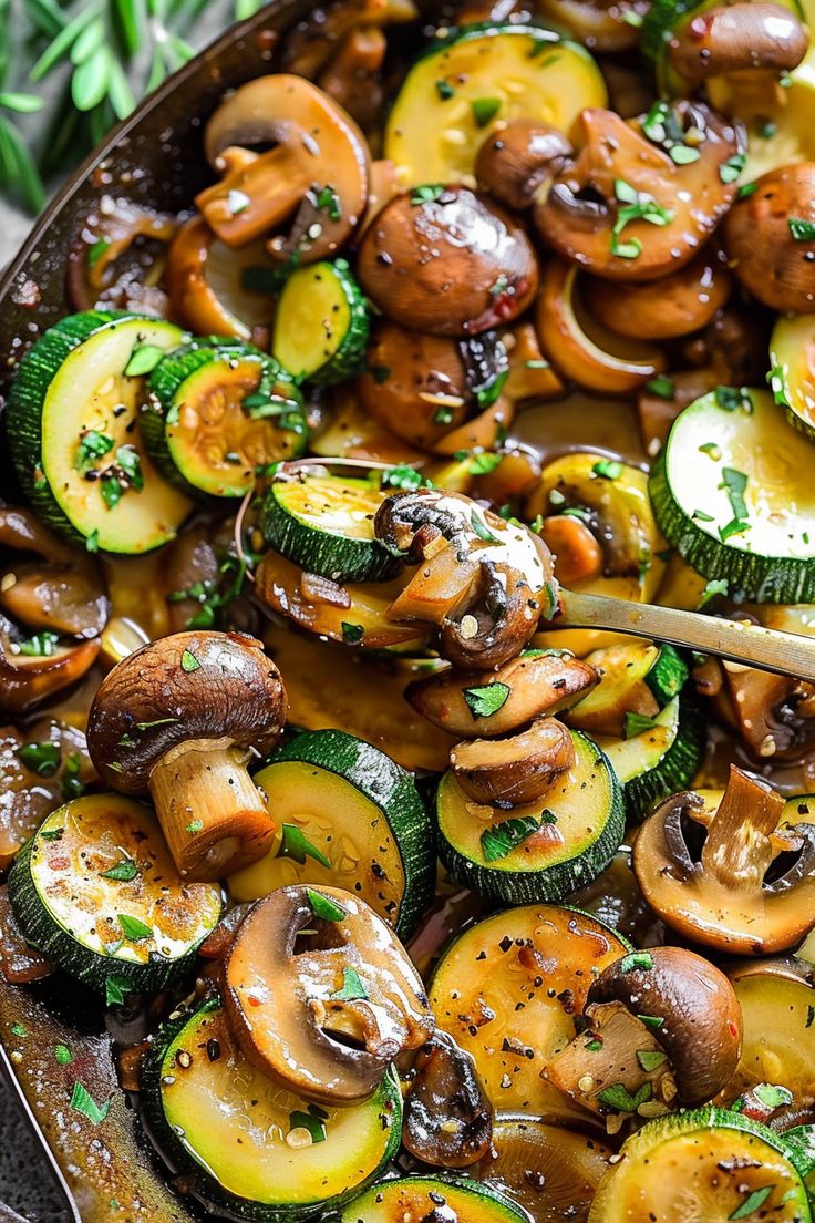 a pan filled with mushrooms and zucchini