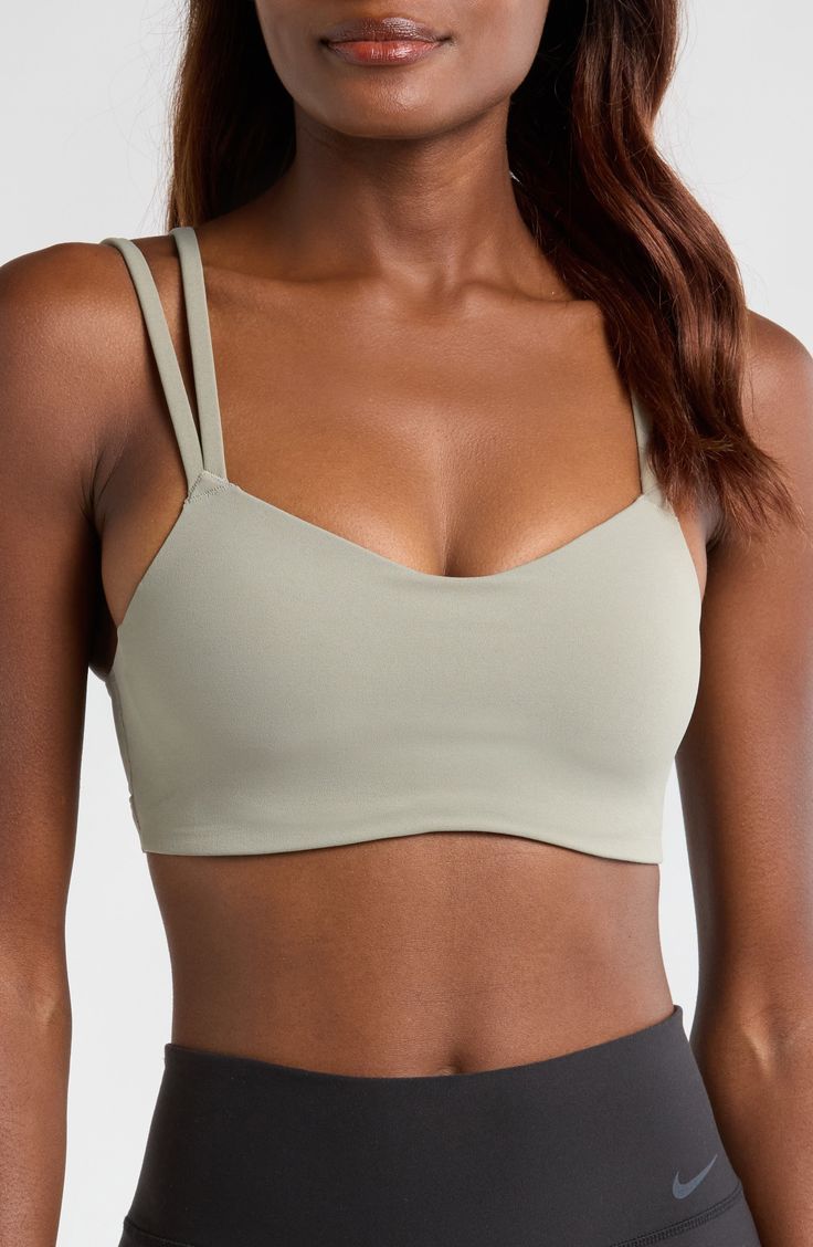 Signature Dri-FIT tech keeps you dry and comfortable in this strappy sports bra with a foam pad insert for extra coverage. Elasticized straps Dri-FIT moisture-wicking technology Lined 63% nylon, 37% spandex Machine wash, line dry Imported Strappy Sports Bra With Built-in Bra, Nike Sports Bra With Built-in Bra For Training, Adjustable Straps Sports Bra For Pilates, Adjustable Strappy Sports Bra For Gym, Supportive Sports Bra With Straps For Workout, Strappy Sports Bra With Adjustable Straps For Pilates, Strappy Sports Bra With Adjustable Straps For Gym, Nike Sports Bra With Built-in Bra For Yoga, Nike Yoga Sports Bra With Built-in Bra