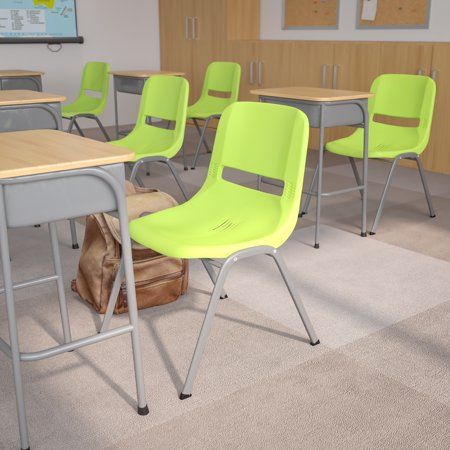 an empty classroom with desks and chairs in front of a map on the wall