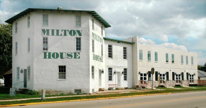 a large white building sitting on the side of a road