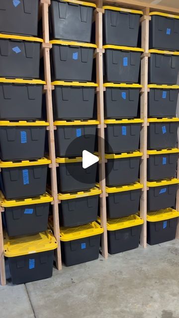 the shelves are filled with plastic bins and yellow tape to keep them from falling