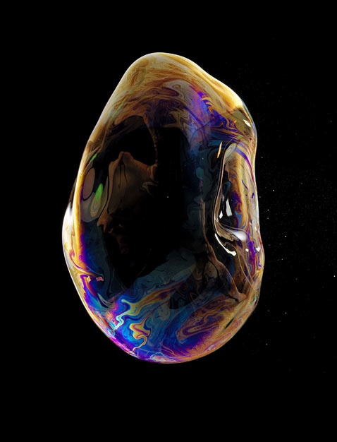 an image of soap bubbles floating in the air with colors changing from yellow to blue