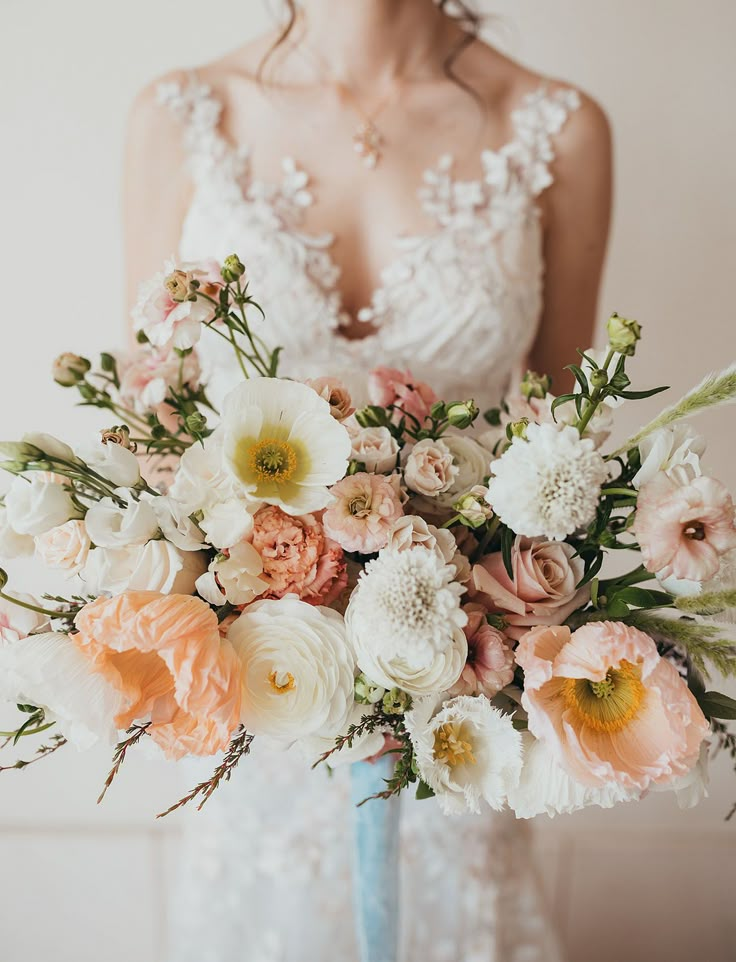 a woman holding a bouquet of flowers in her hands