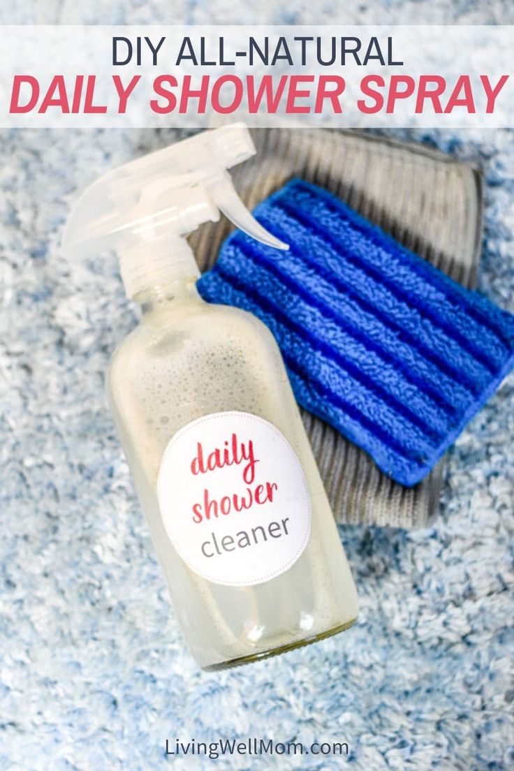 a bottle of diy all natural daily shower spray next to a blue sponge