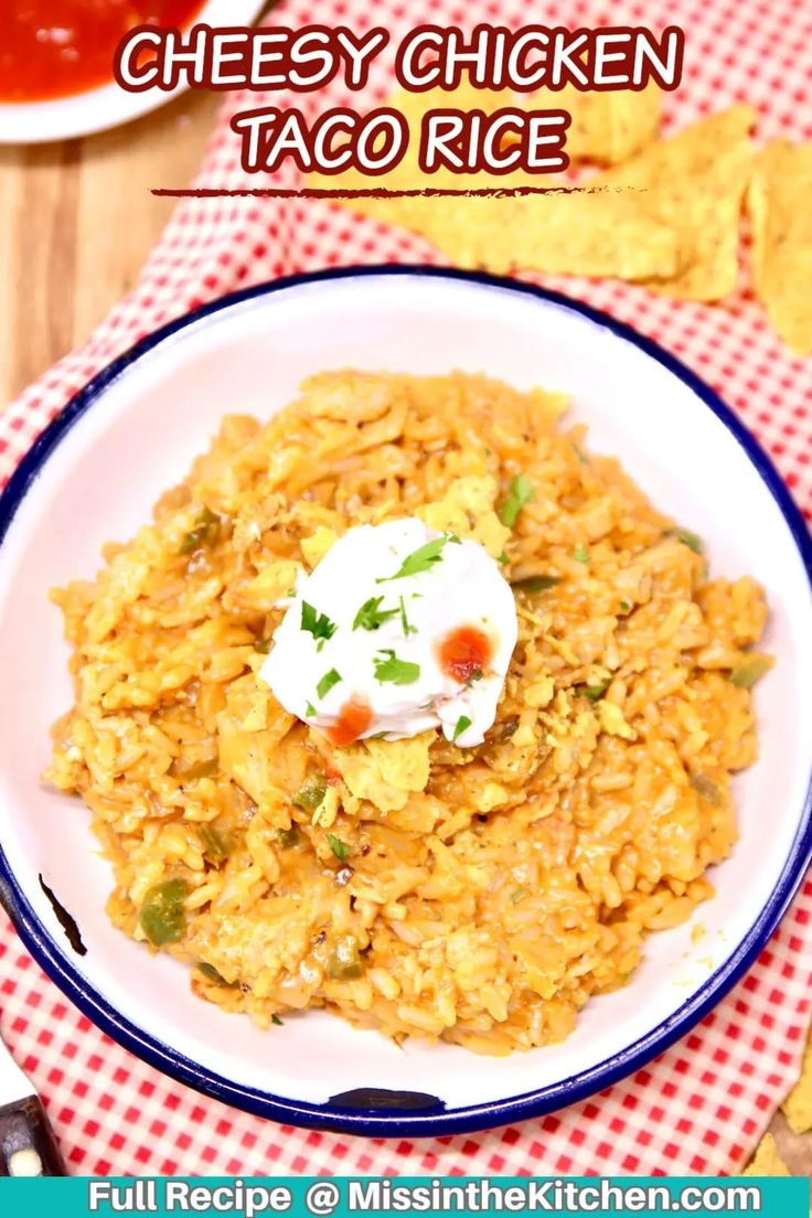 a white plate topped with rice covered in sour cream and garnished with cilantro