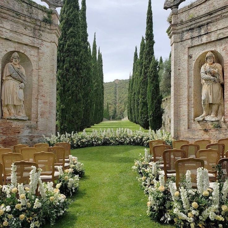 an outdoor ceremony set up with chairs and flowers