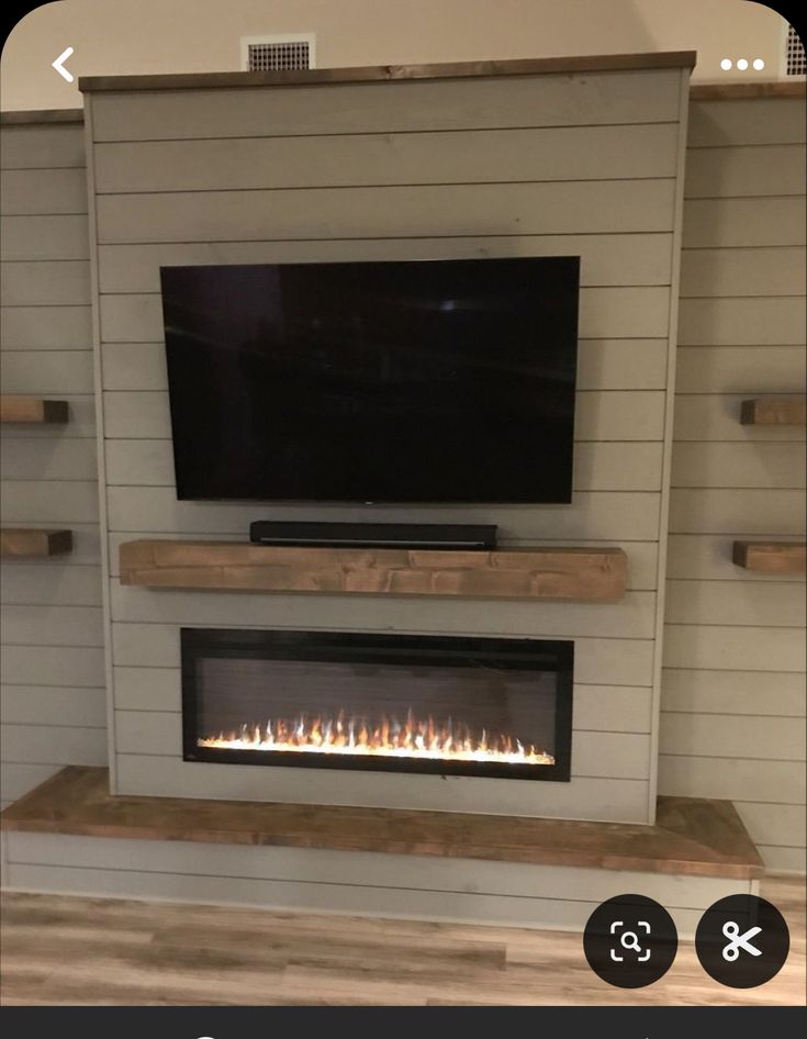 a flat screen tv mounted above a fireplace